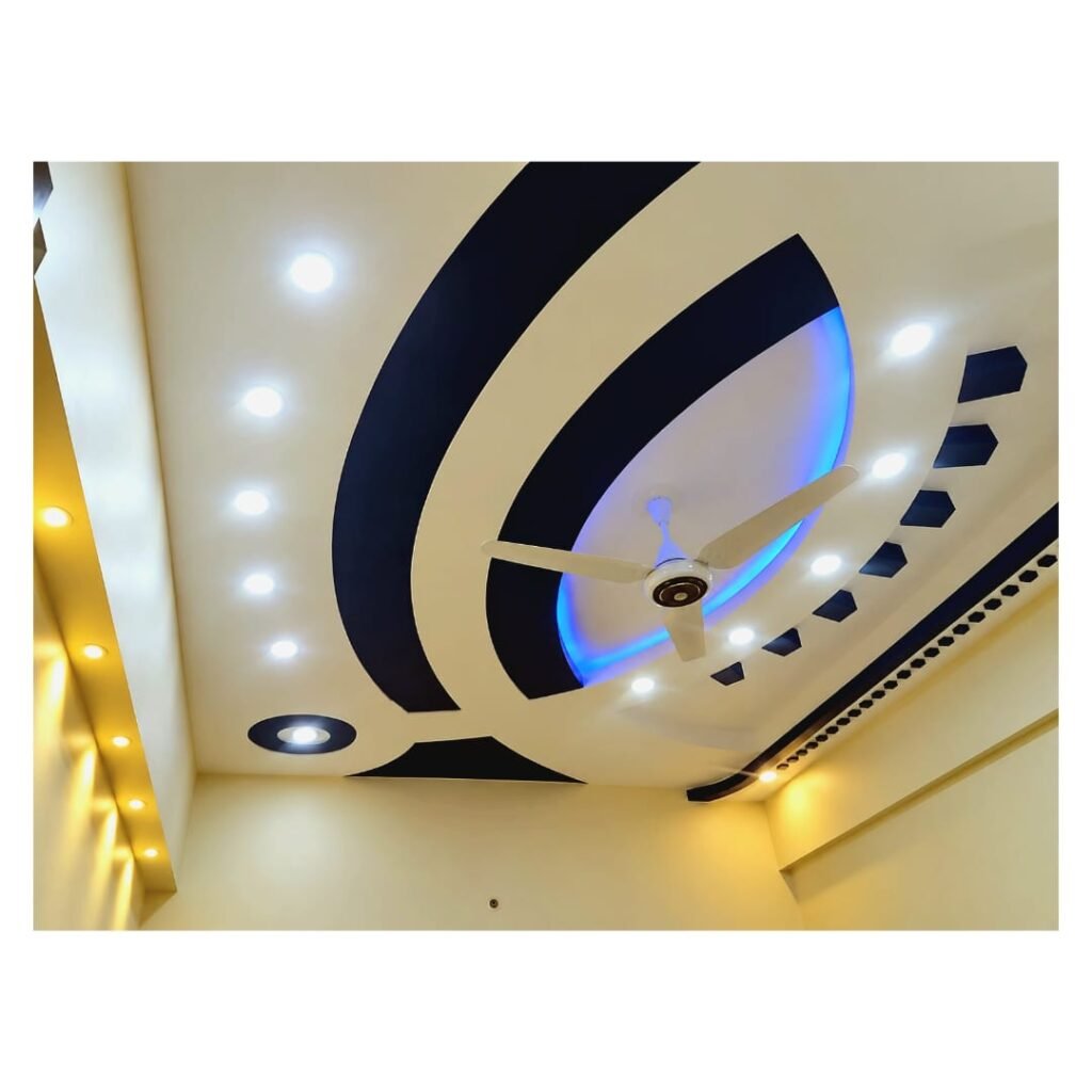 ​Modern gypsum false ceiling design with curved elements, black and blue LED lighting, and surface spotlights installed in a room.